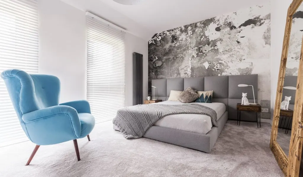 blue accent chair in a grey themed room