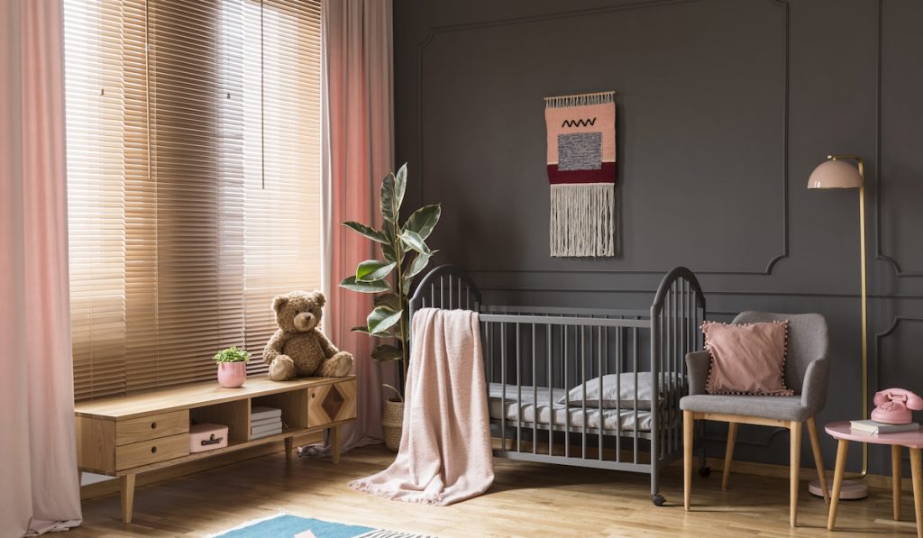 beige blinds matching the grey and peach theme of nursery room